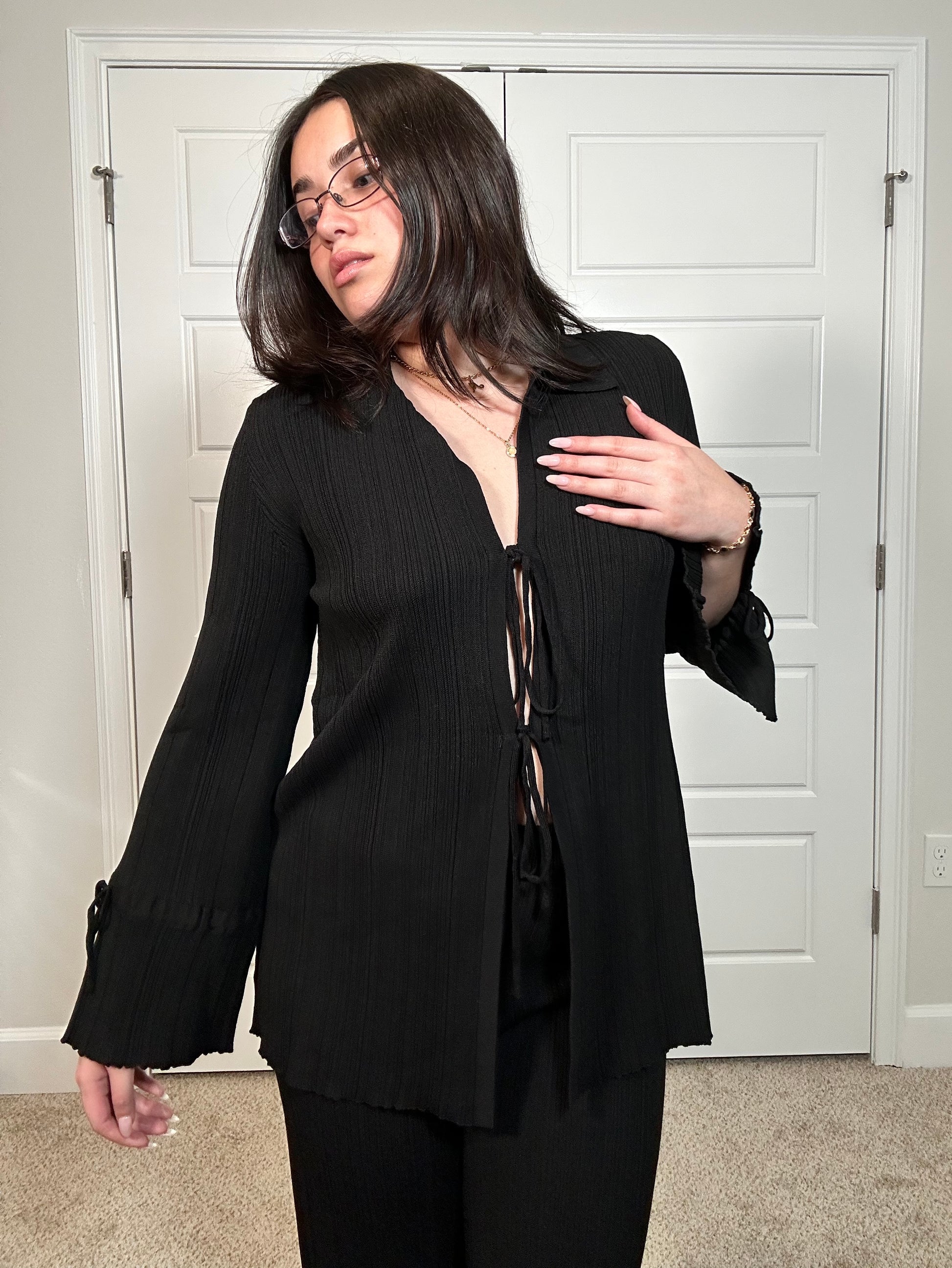 Black textured knit long sleeve cardigan with tie in the middle