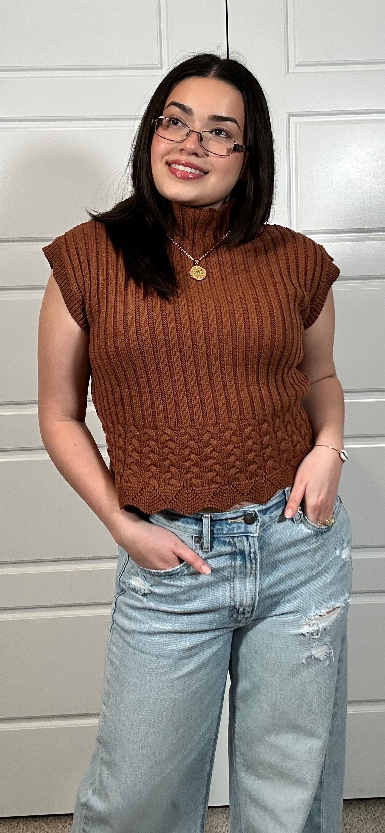 Rust colored cable knit cropped sleeveless sweater