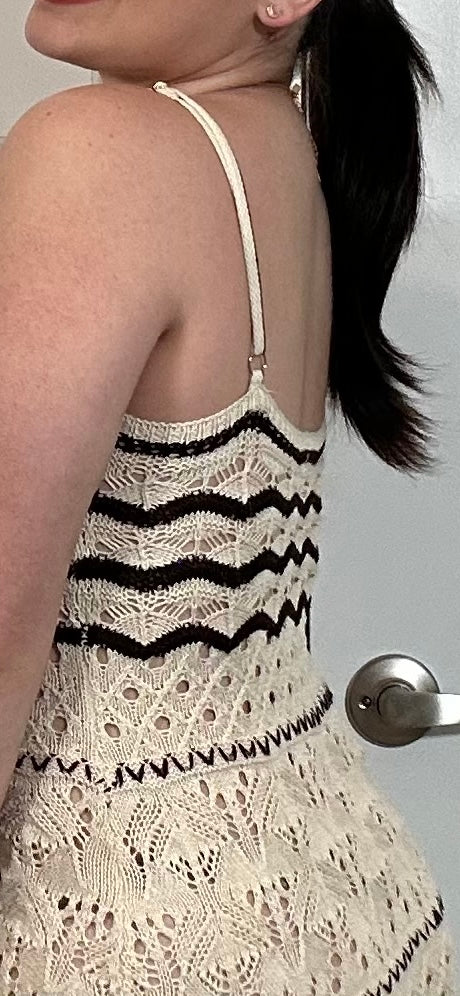 Long cream crocheted dress with spaghetti straps, with black stripes and woven details