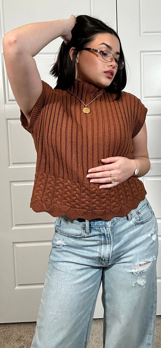 Rust colored cable knit cropped sleeveless sweater