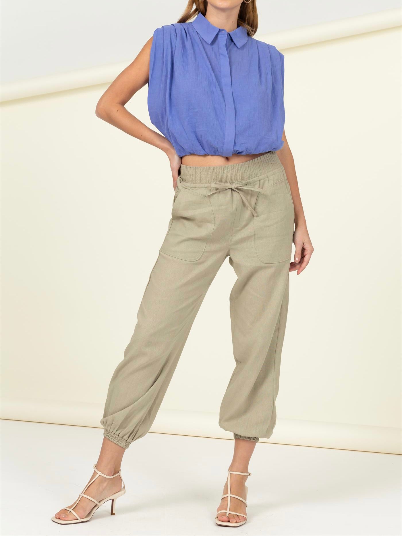 High waisted tan linen blend pants with elastic ankle, drawstring waist, and large pockets