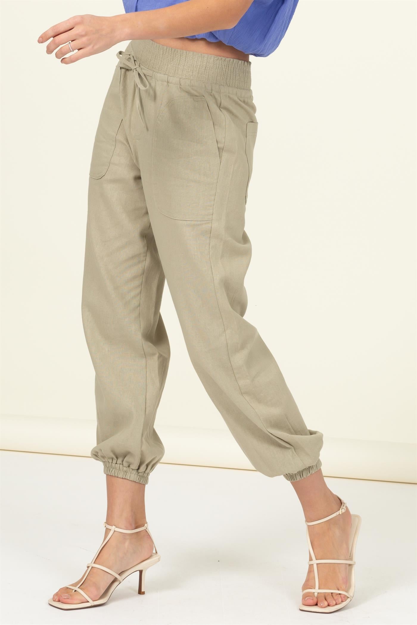 High waisted tan linen blend pants with elastic ankle, drawstring waist, and large pockets