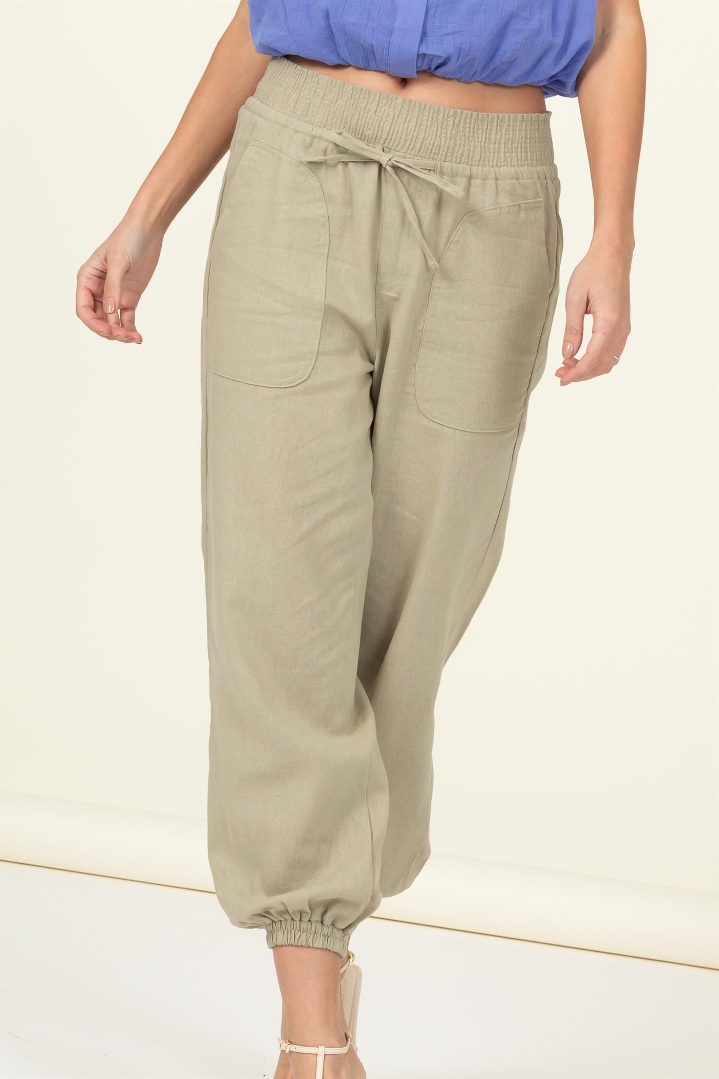 High waisted tan linen blend pants with elastic ankle, drawstring waist, and large pockets