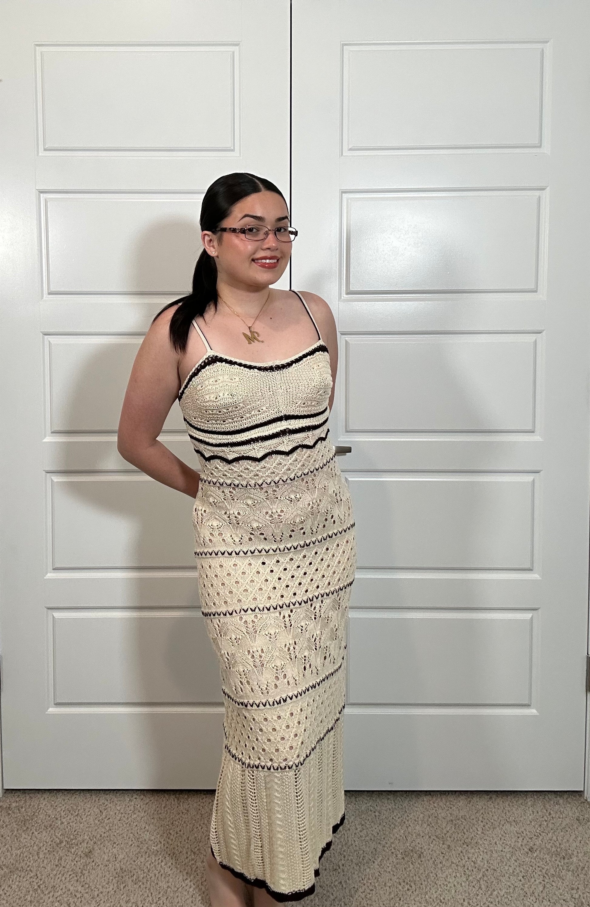 Long cream crocheted dress with spaghetti straps, with black stripes and woven details