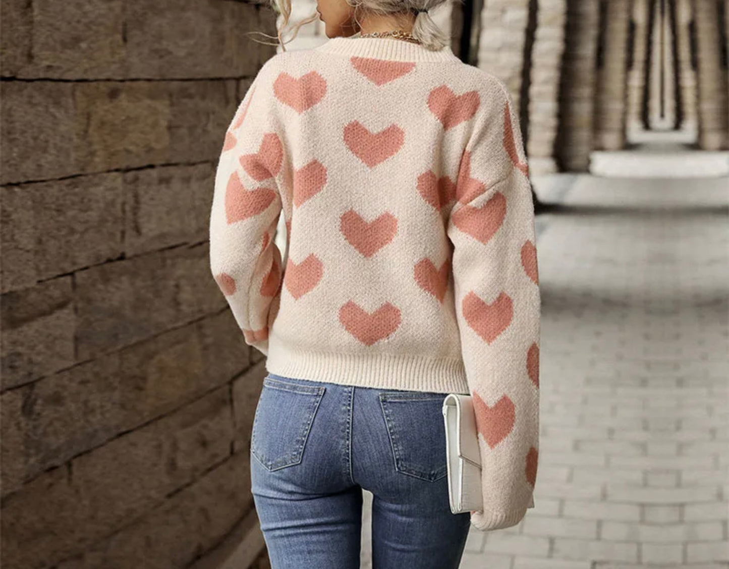 Cream colored knit sweater with pink hearts