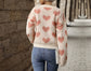 Cream colored knit sweater with pink hearts