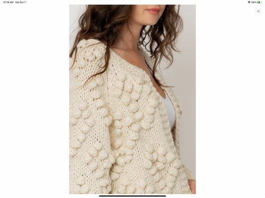 Cream cardigan sweater with pom pom details in heart shape