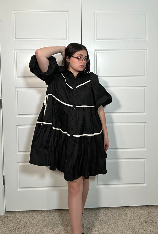 Black tiered dress with puff sleeves and white stripe detail