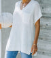 Lightweight white short sleeve sweater with chest pocket and slit detail on the side