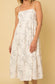 White sleeveless smocked tiered midi dress with black floral design