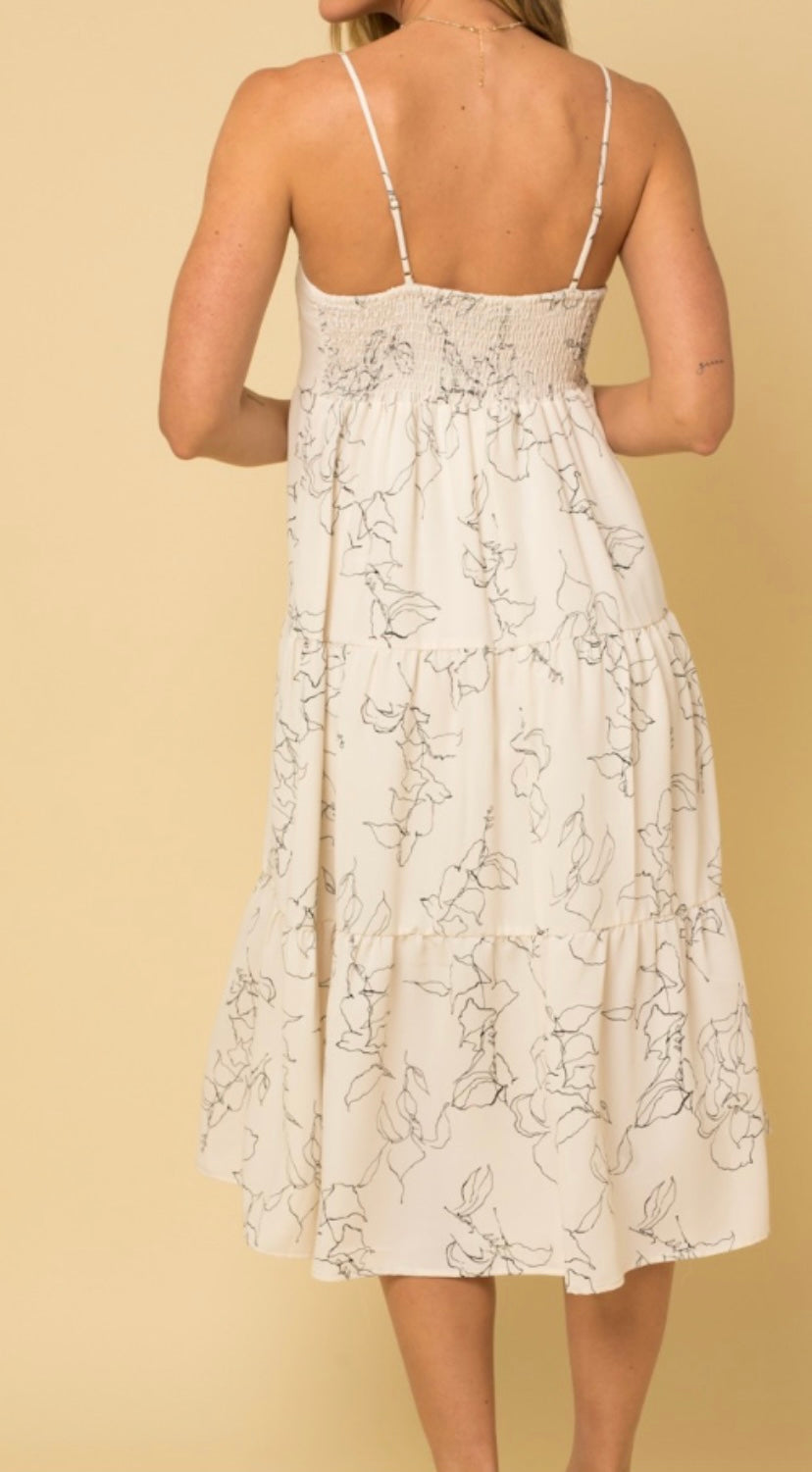 White sleeveless smocked tiered midi dress with black floral design