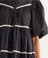 Black tiered dress with puff sleeves and white stripe detail