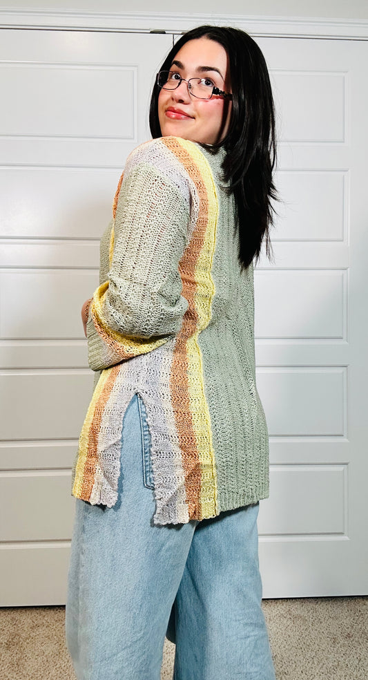 Green long sleeve cardigan with orange and yellow stripes down the side