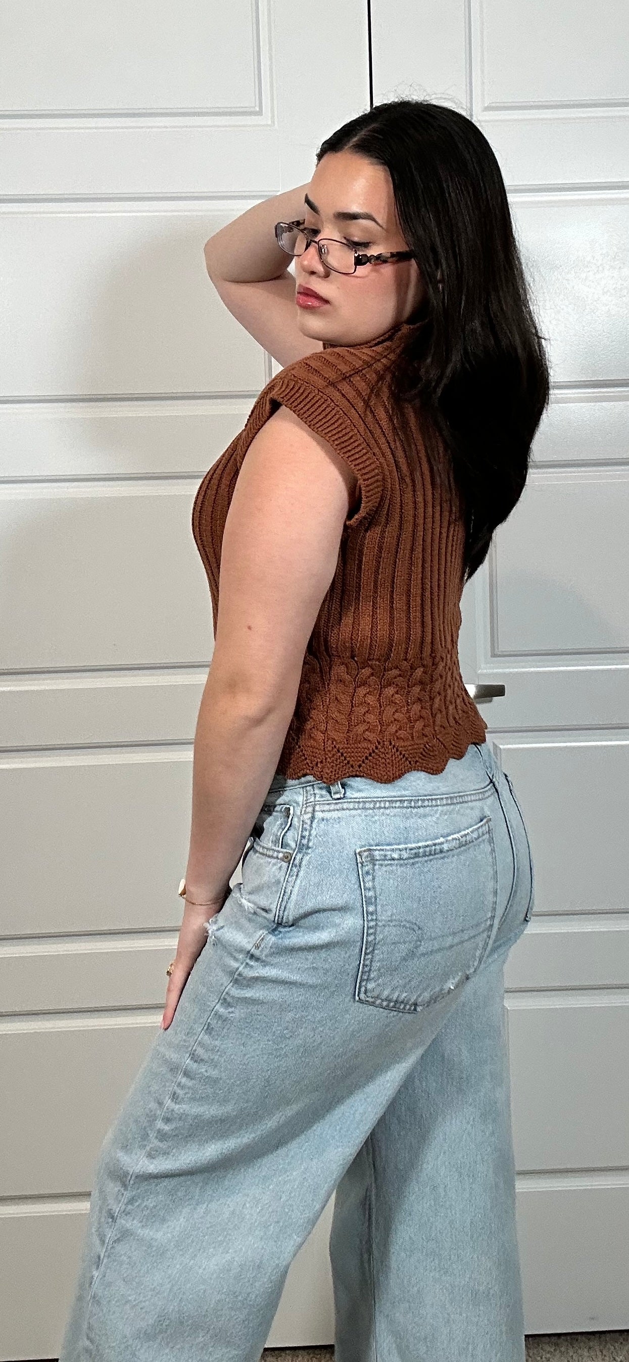 Rust colored cable knit cropped sleeveless sweater