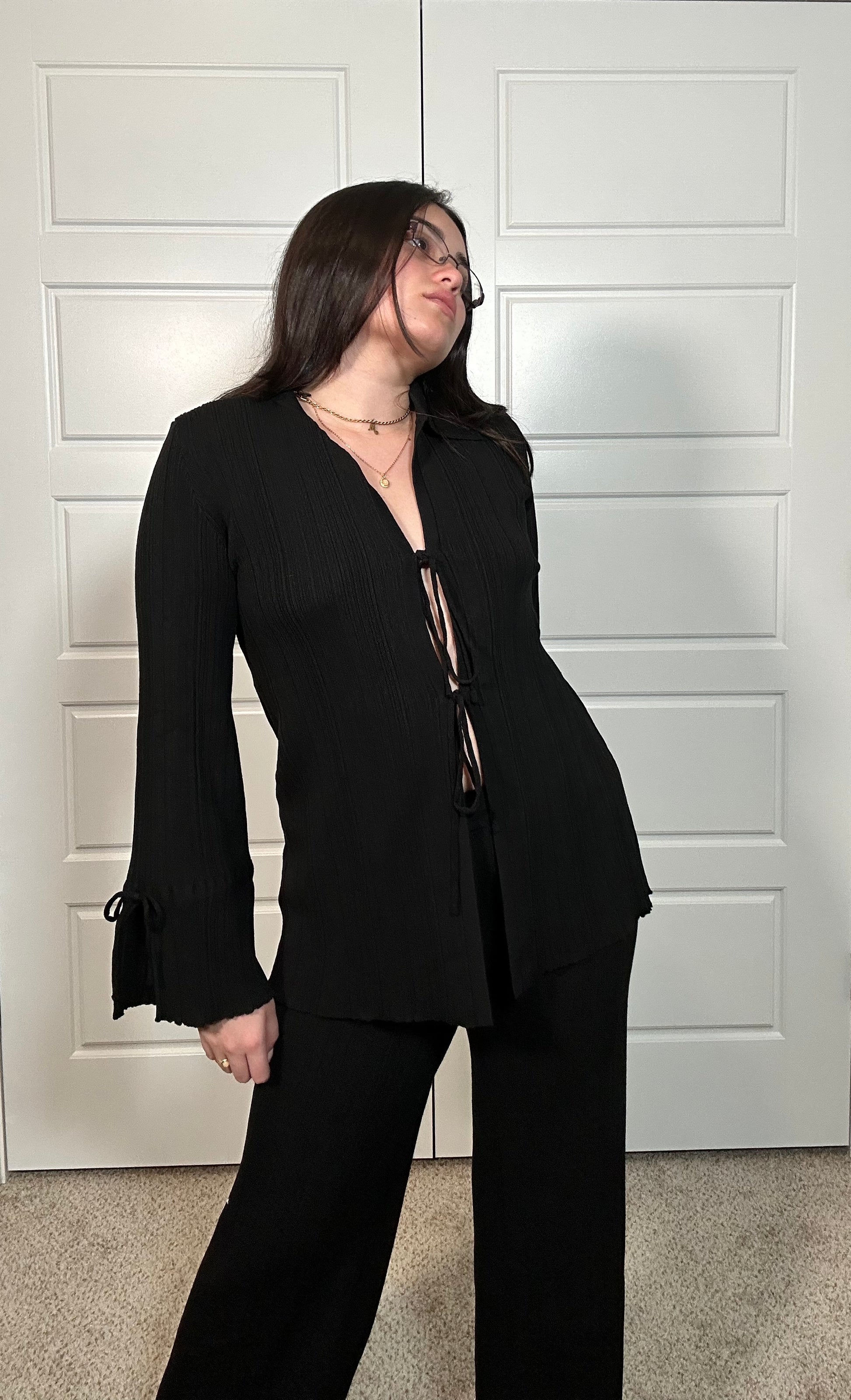 Black textured knit long sleeve cardigan with tie in the middle