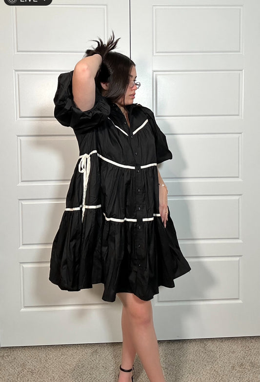 Black tiered dress with puff sleeves and white stripe detail