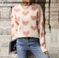 Cream colored knit sweater with pink hearts