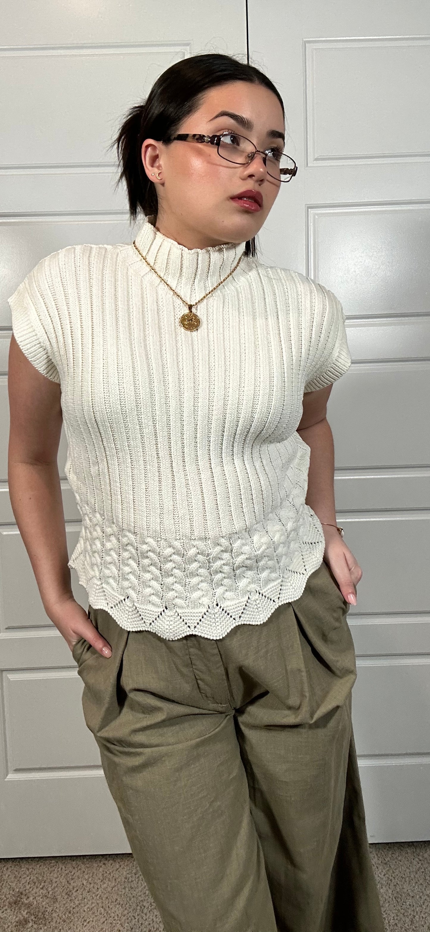 White cable knit cropped sleeveless sweater with mock neckline