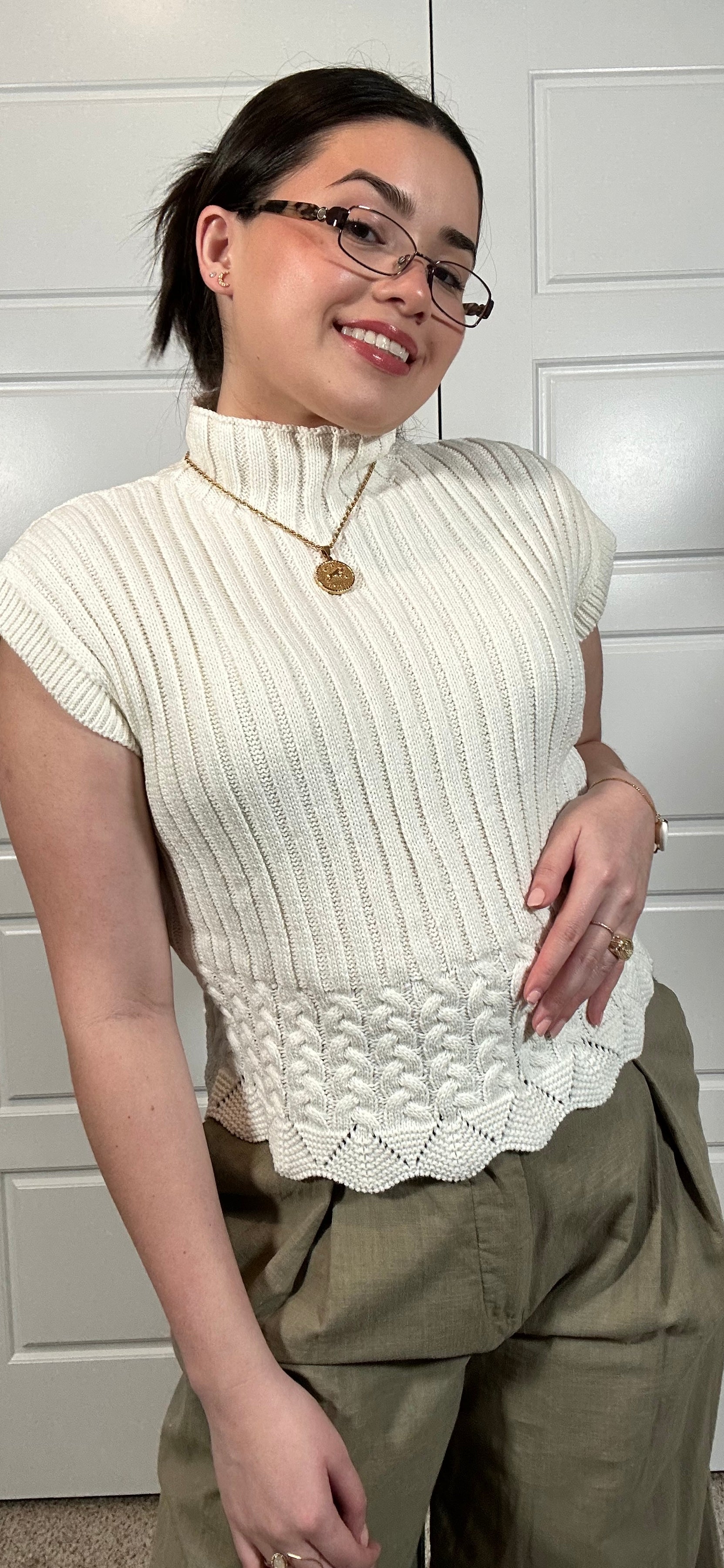 White cable knit cropped sleeveless sweater with mock neckline